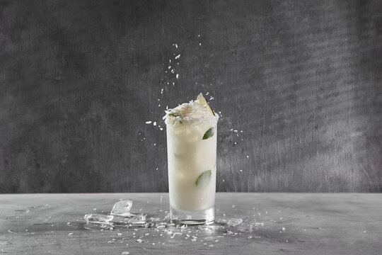 refreshing cocktail, coconut mojito on gray background