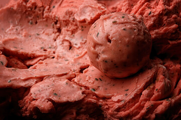 A scoop of strawberry ice cream close-up