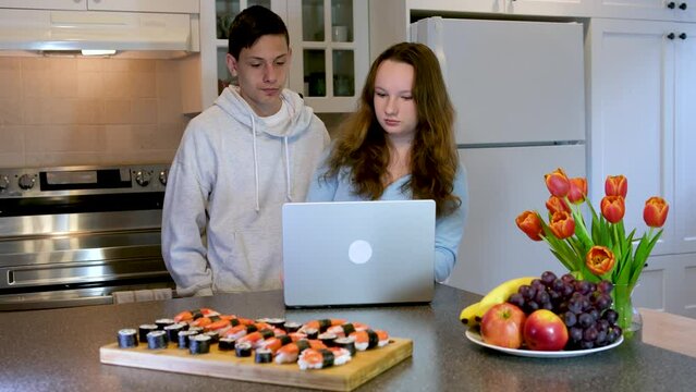 teenagers doing homework in the kitchen ordered sushi meet after school first date watch movie spend time together boy girl 13 14 15 years old