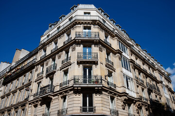 The facade of traditional French house with typical balconies and windows. Paris.