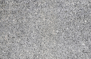Closeup of a granite stone surface. White and black texture of a polished natural crystalline rock as a background