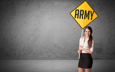 Young business person holding road sign