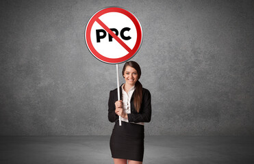 Young business person holdig traffic sign