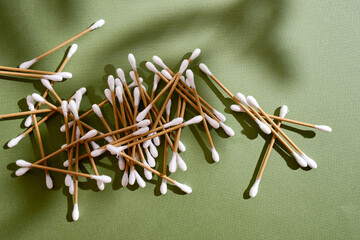 Bamboo cotton buds on a colored background. Biodegradable ear swabs. Eco product