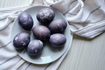 Purple eggs on a light background. Easter eggs concept. View from above. Easter card with copy space for text