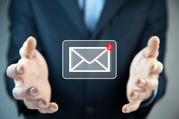 Businessman hand holding e-mail icon, Contact us by newsletter email
