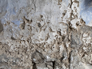 texture of a deteriorated old wall, with a partially repaired spalling, grunge cracked concrete...
