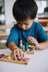 Young child, blond Caucasian boy, playing quietly with wooden toys, surrounded by a peaceful atmosphere. AI generative illustration of Montessori study materials