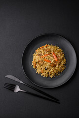 Delicious Uzbek pilaf with chicken, carrots, barberry, spices and herbs
