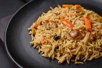Delicious Uzbek pilaf with chicken, carrots, barberry, spices and herbs