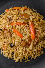 Delicious Uzbek pilaf with chicken, carrots, barberry, spices and herbs