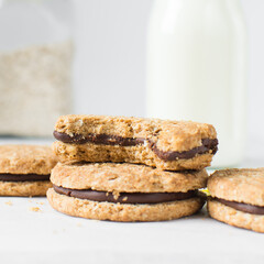 oat cookies with chocolate filling, homemade oatmeal cookies filled with chocolate ganache, thin oat biscuits with chocolate ganache