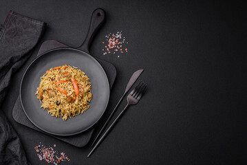 Delicious Uzbek pilaf with chicken, carrots, barberry, spices and herbs - obrazy, fototapety, plakaty