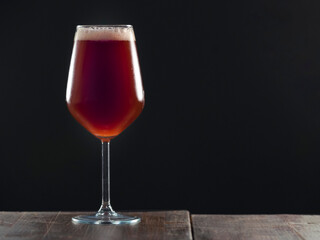 A glass of delicious craft beer served on an authentic beer glass, to be used as a background