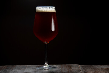 A glass of delicious craft beer served on an authentic beer glass, to be used as a background