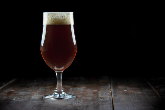 A glass of delicious craft beer served on an authentic beer glass, to be used as a background