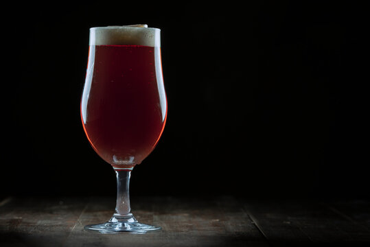 A glass of delicious craft beer served on an authentic beer glass, to be used as a background