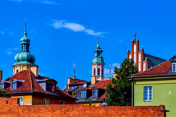Fototapeta premium Rooftops John's Archcathedral, Jesuit Church in Warsaw, St. Martin's Church, Warsaw. Beautiful architecture with houses in Polish capital Warsaw.