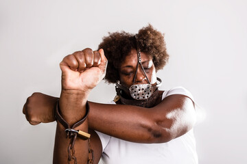 Portrait of a woman trapped with old rusty chains and mask on her face.