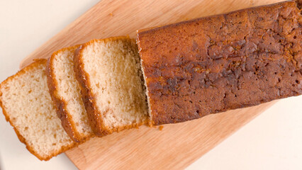 slices of bread getting sliced on wooden board