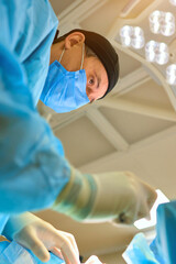 plastic surgeon operates on a patient in the operating room