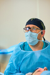 Fototapeta na wymiar plastic surgeon operates on a patient in the operating room
