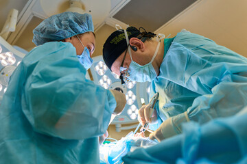 plastic surgeon operates on a patient in the operating room