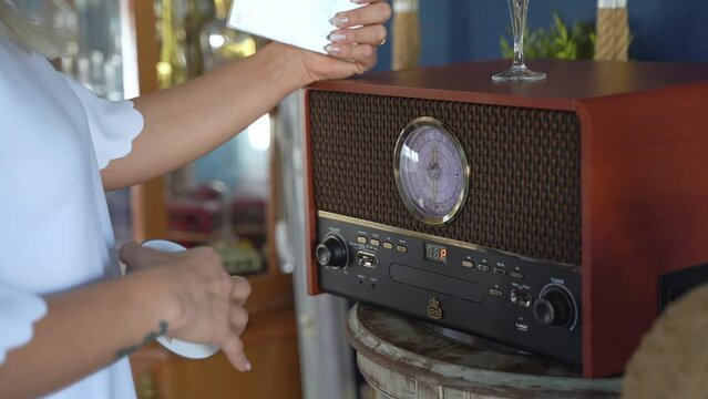 Close-up Woman Changes Music Cds in Vintage CD-Player At Home. Relaxation, Leisure, Hobby, Music in Daily Life. Generative AI