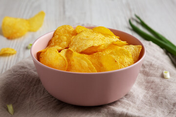 Crunch Green Onion Potato Chips in a Pink Bowl, side view.