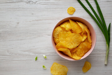 Crunch Green Onion Potato Chips in a Pink Bowl, top view. Flat lay, overhead, from above. Copy space.