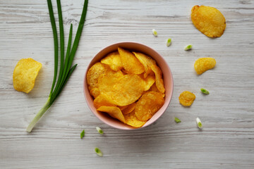 Crunch Green Onion Potato Chips in a Pink Bowl, top view. Flat lay, overhead, from above.