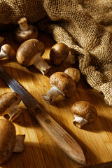 Close up of brown mushrooms on a wooden board
