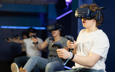 Young man using virtual reality glasses delighted with videogames and new tech
