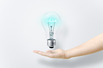 Idea text glowing inside a light bulb.