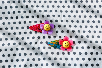 Dot background and smile flower hairpin.