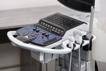 Modern ultrasound machine and medical equipment in the clinic for internal organ scanning and examination. Close-up of probes and dopplers for ultrasound diagnostics. Elastography and sonography.