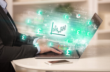 Young man watching stock market on laptop