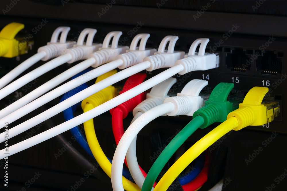 Poster multi colored network cables connected to switch, network technology concept