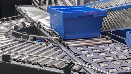 Crossing of the roller conveyor with plastic boxes, Production line conveyor roller transportation...