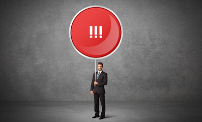 Obraz premium Young business person holdig traffic sign concept