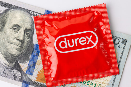 An image of a red Durex condom package along with dollar bills.