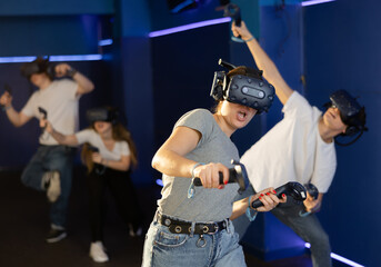 Fototapeta na wymiar Friends using virtual reality glasses - people having fun with technology vr headset. High quality photo