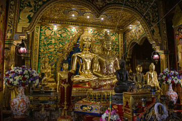 Golden Buddhas in Wat Mung Muang interior of the temple at Chiang Rai