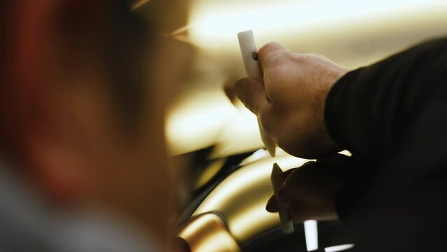 Removing a car dent with a PDR tool. Close-up shot. Repai shop concept. High quality 4k footage