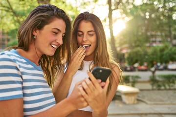 Friends surprised by social media post in park.