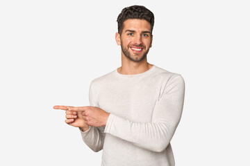 Young handsome man isolated excited pointing with forefingers away.