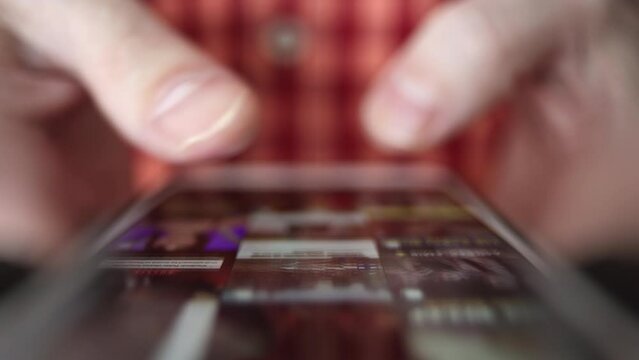 smartphone in hand, a person browses news, social networks and photos, new posts. conducts business remotely through the app, pays taxes, corresponds and talks via video communication. modern