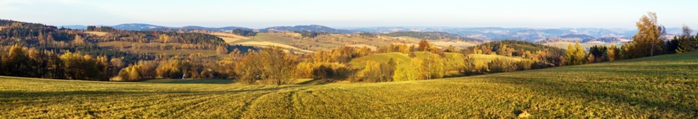 autumn panorama with meadows fields and forests