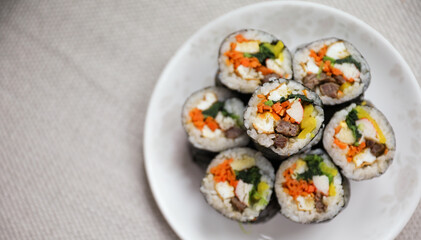 Kimbap is a traditional Korean dish made of rice, vegetables, and meat or seafood rolled in seaweed. It represents the country's rich culinary heritage and cultural diversity