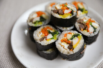 Kimbap is a traditional Korean dish made of rice, vegetables, and meat or seafood rolled in seaweed. It represents the country's rich culinary heritage and cultural diversity